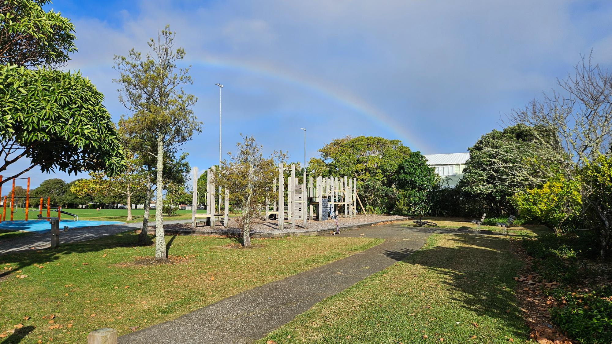 Bayswater Park playground equipment beside wide open green space for sport and picnics