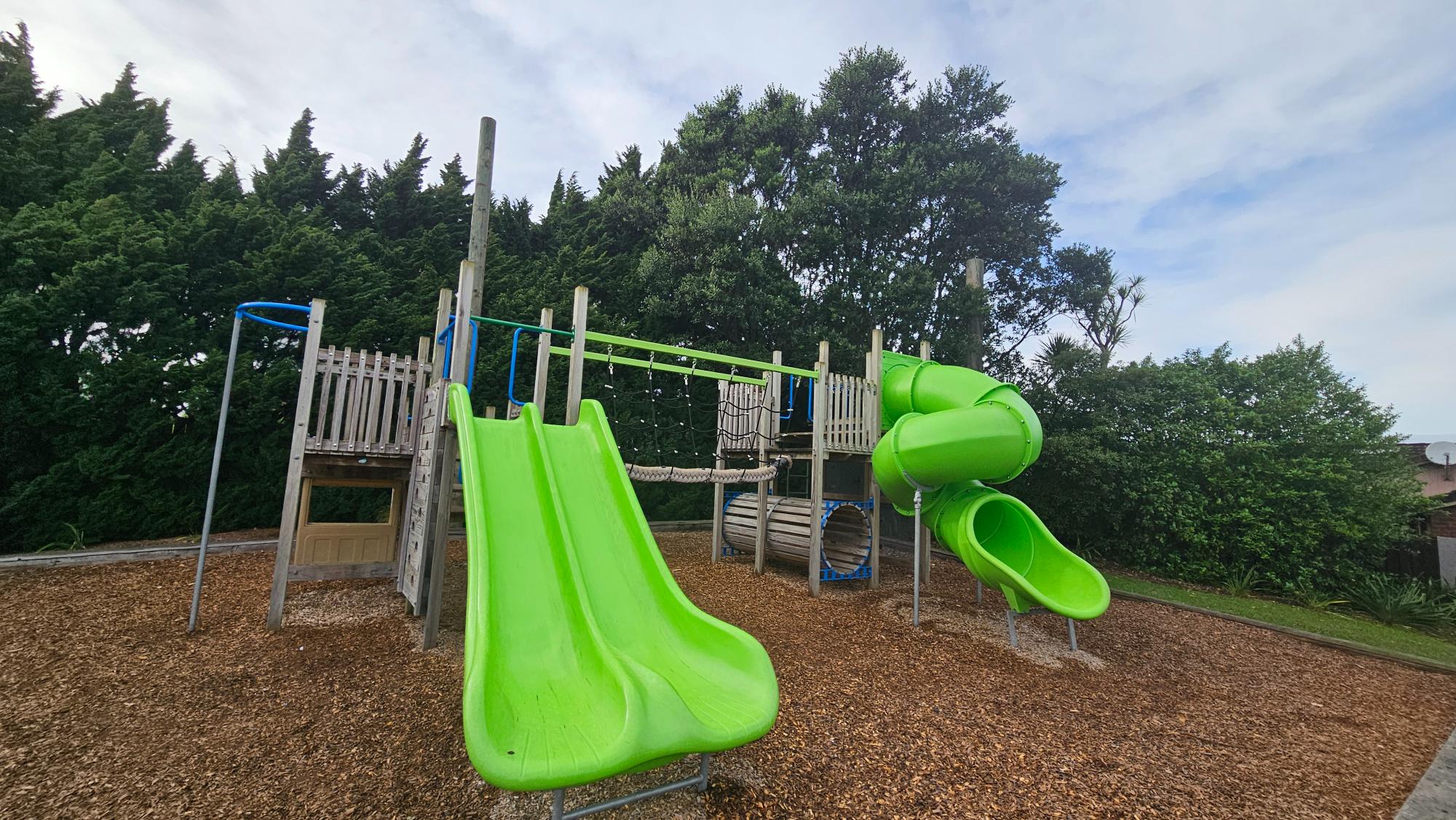 Slides and climbing structure — clean timber, slightly older scale
