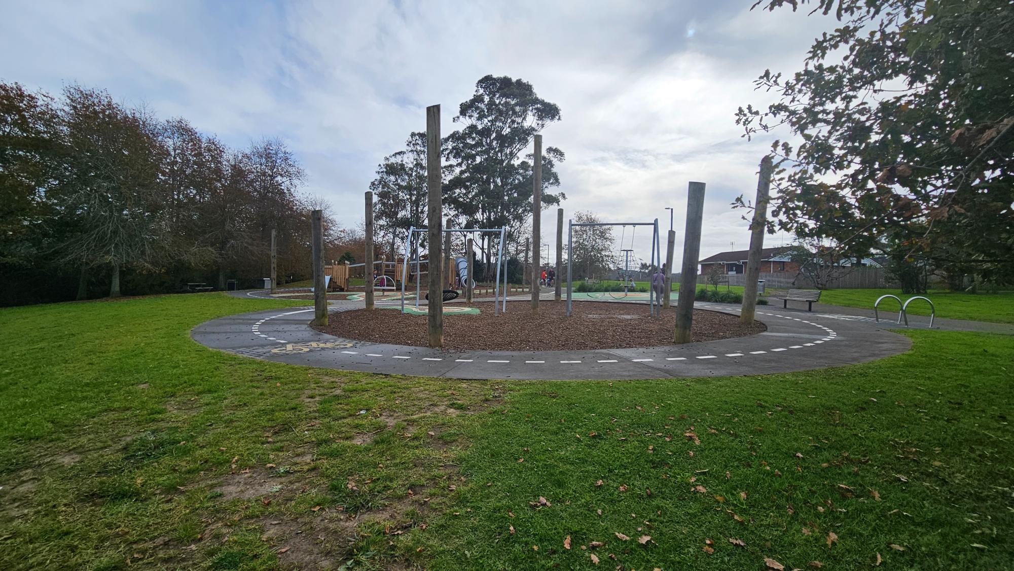 Bike track surrounding the play area — loops that keep kids on wheels busy