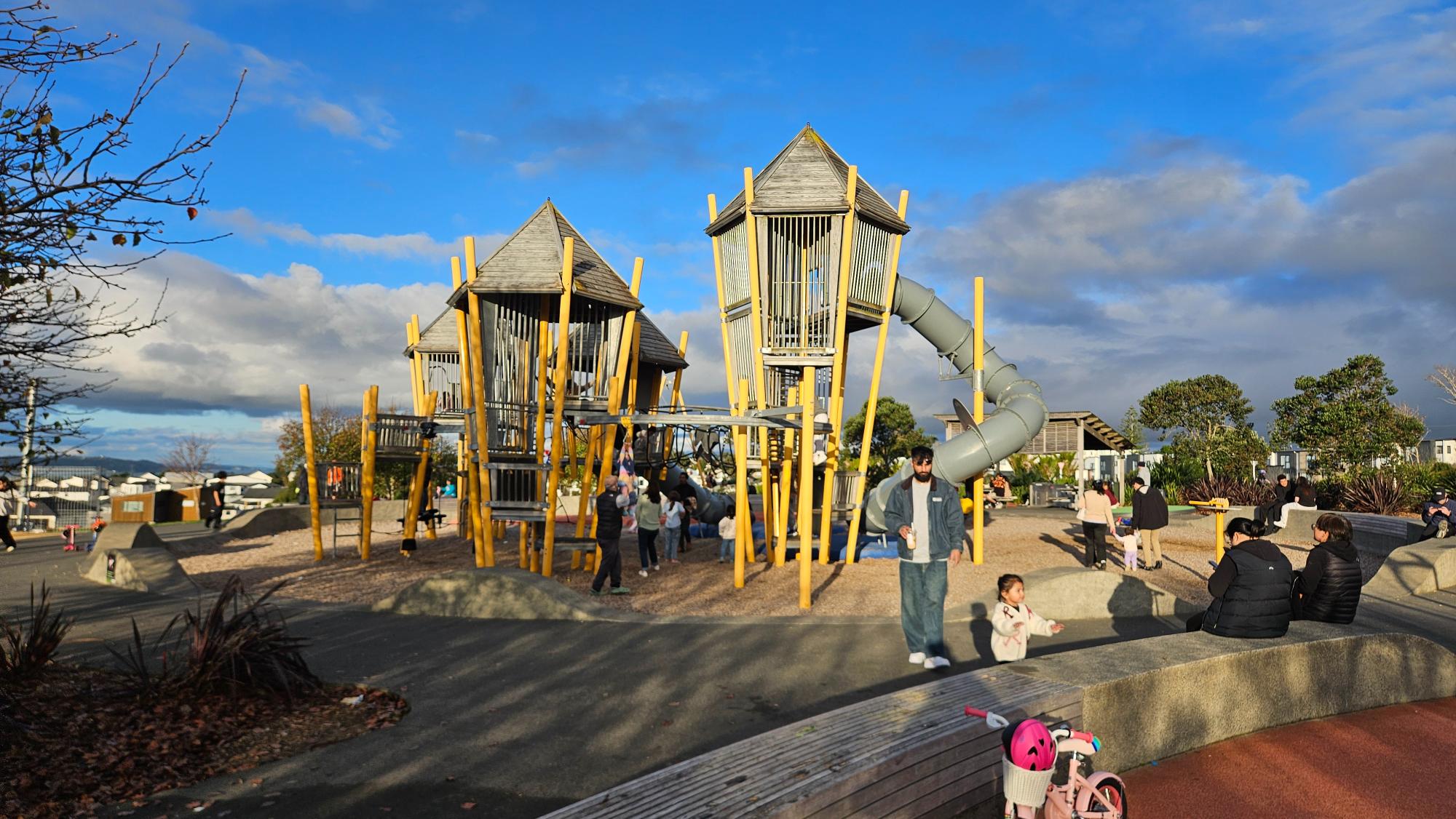 Two tall wooden towers with a large tube slide
