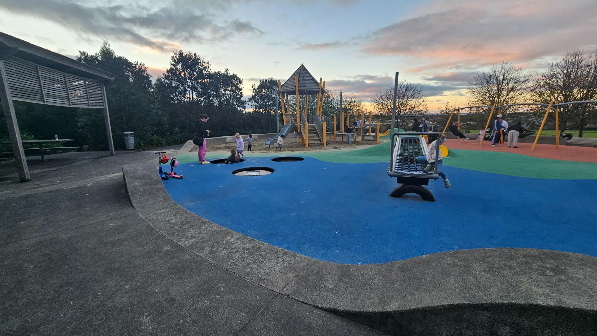 Toddler zone with rubber surfacing, built-in trampolines, and parent-friendly seating around the edge