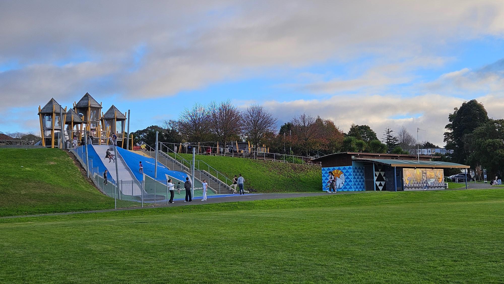 The wide hill slide is built into the slope, and there is also a toilet building nearby.
