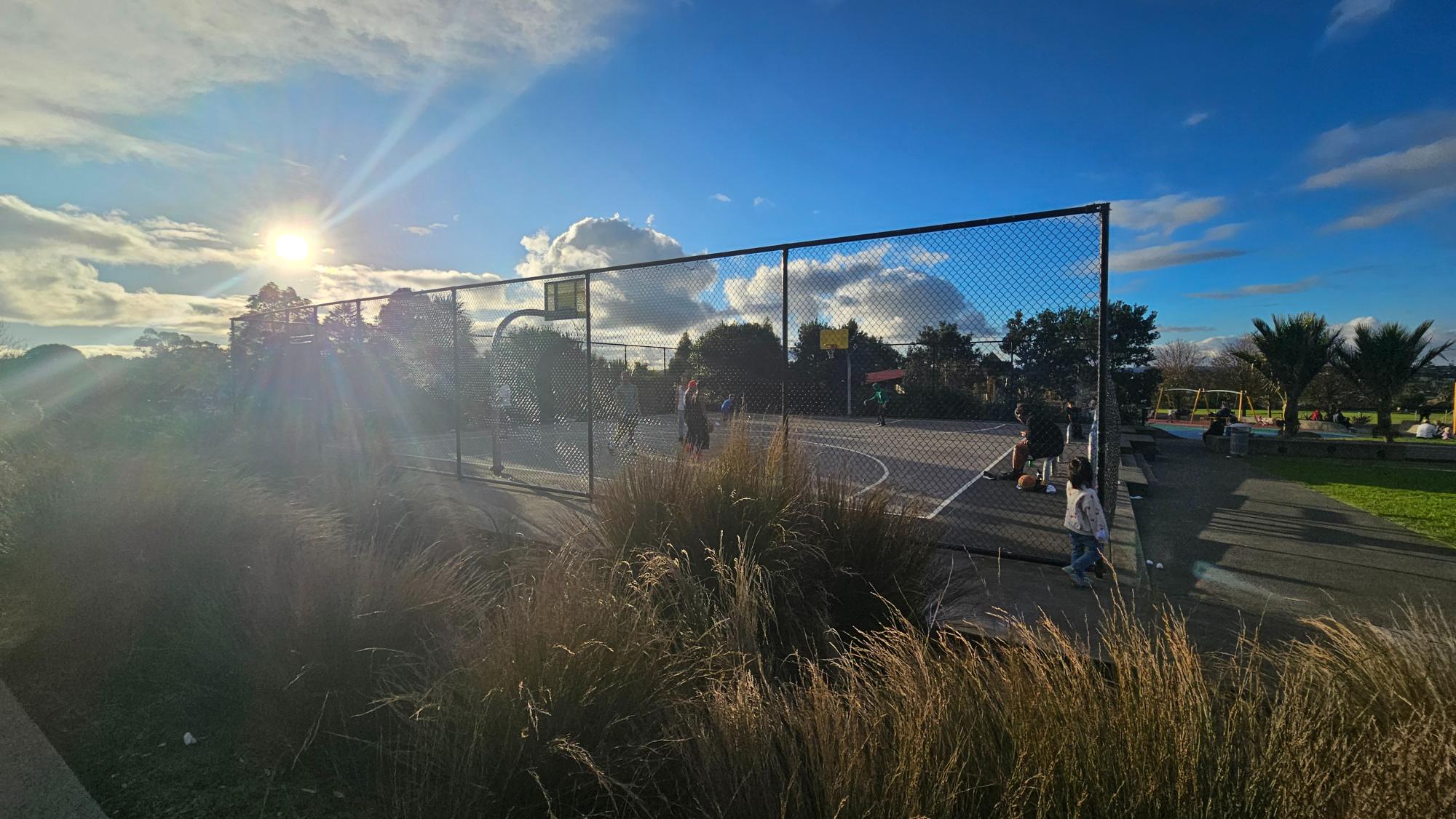 Basketball court at the park entrance — busy on weekends but worth a look