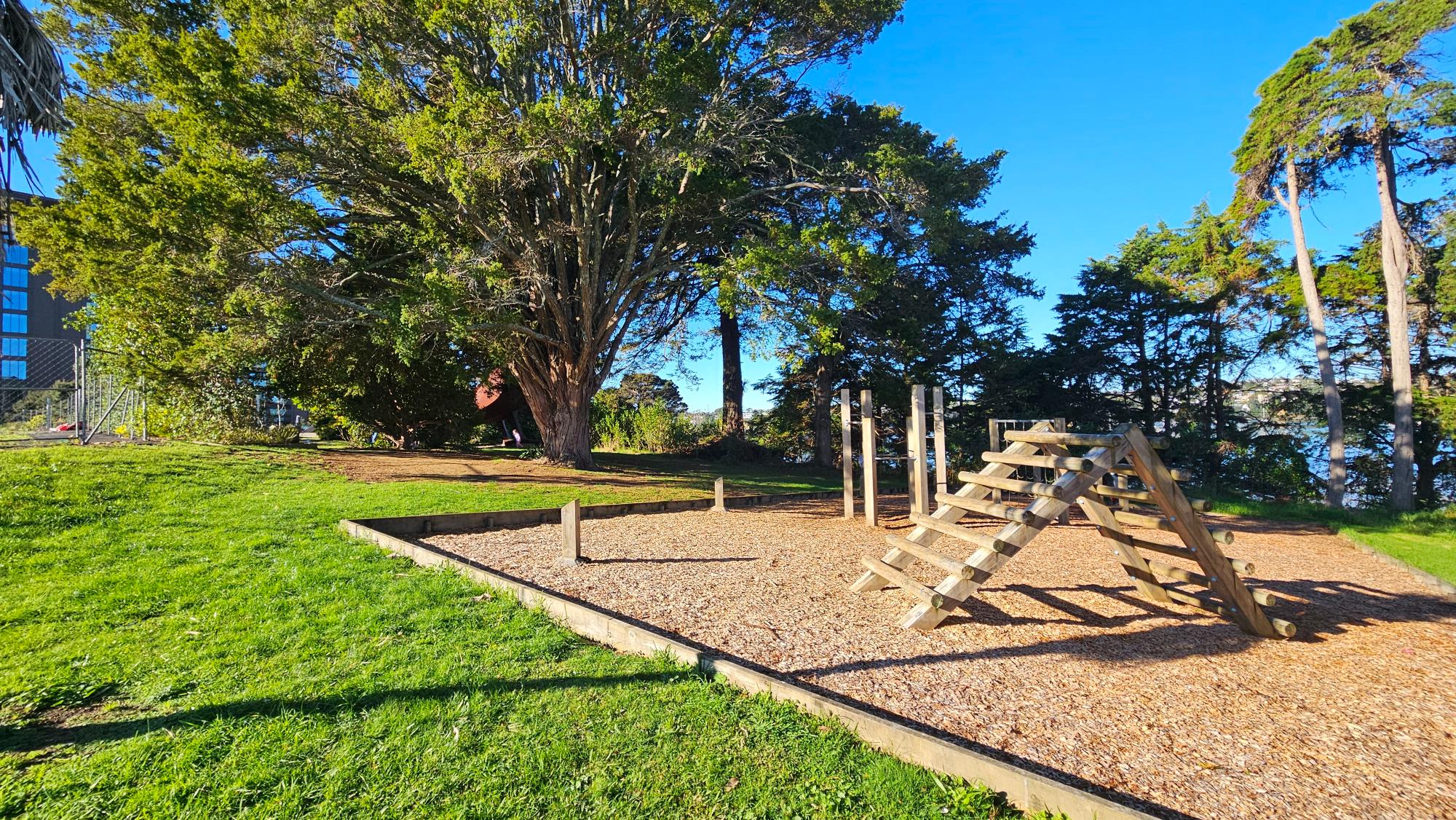 General play area with wooden-climbing frame — easy to overlook at first among the trees