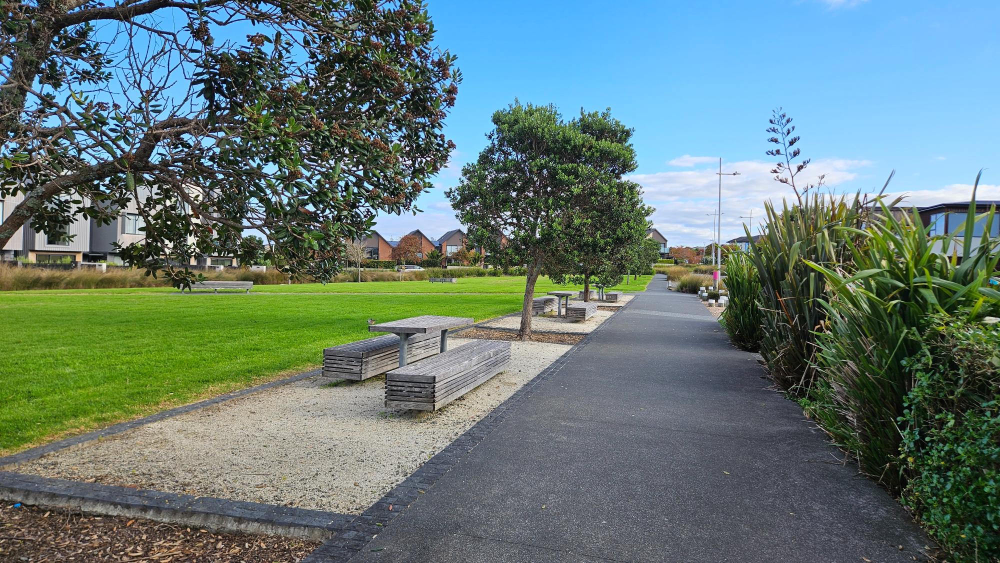 A paved path wraps around the playground, making it easy to get around with a bike or stroller. There are four or five picnic tables, all clean, nearly new, and more than enough.