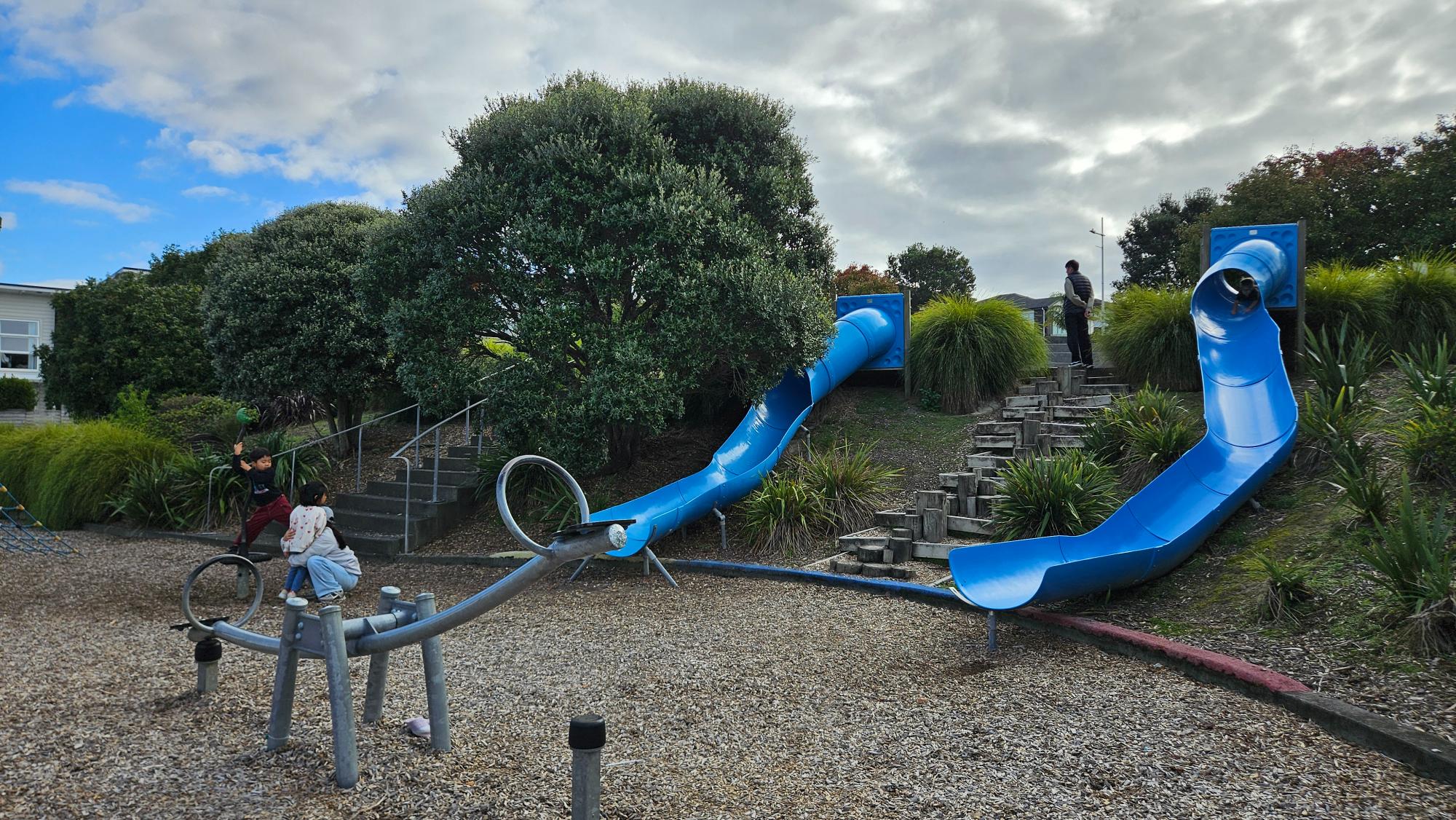 Two open-air tunnel slides built into a hillside