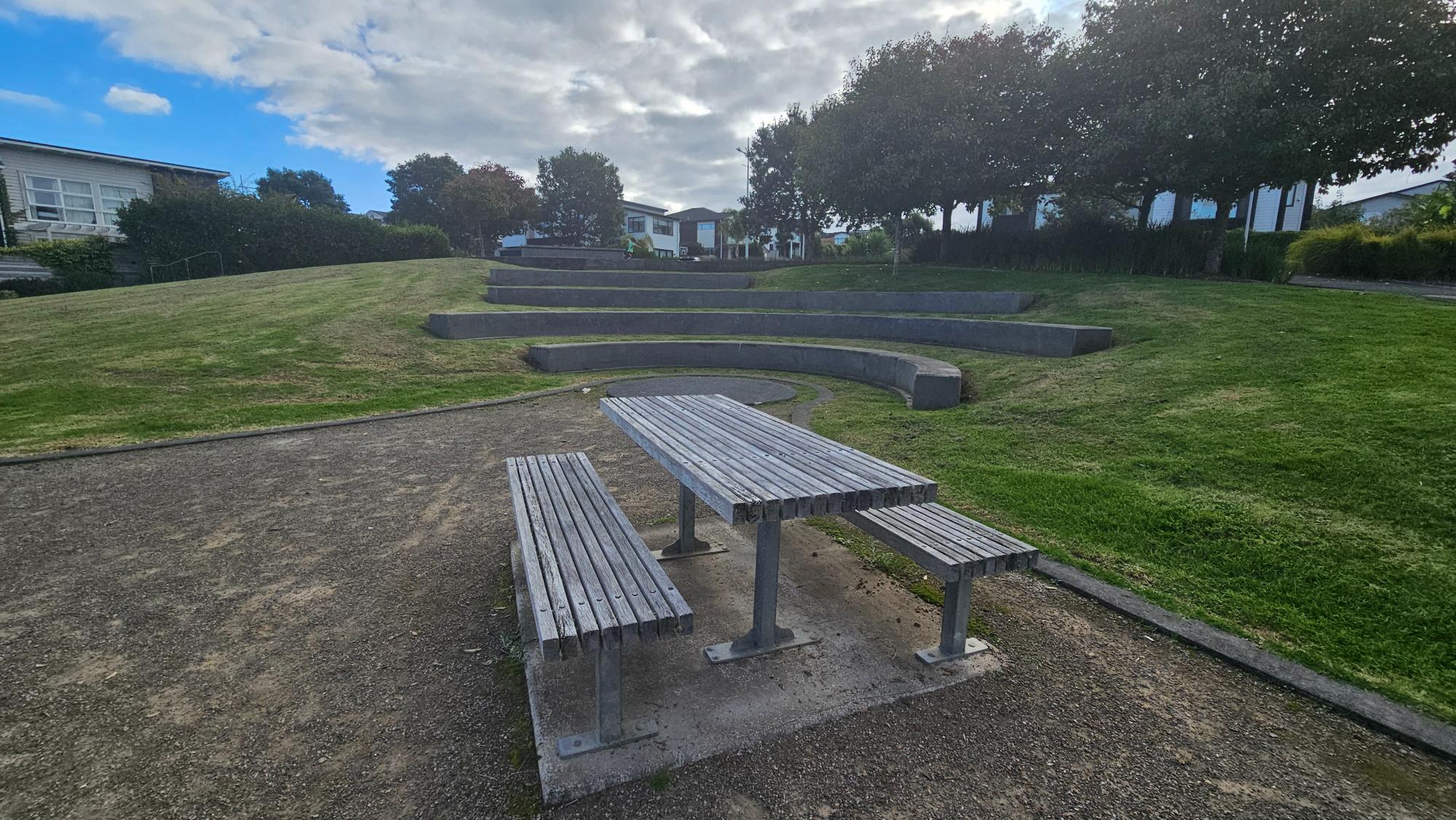 Walk past the playground, and you’ll come across a picnic table and a small circular stage.