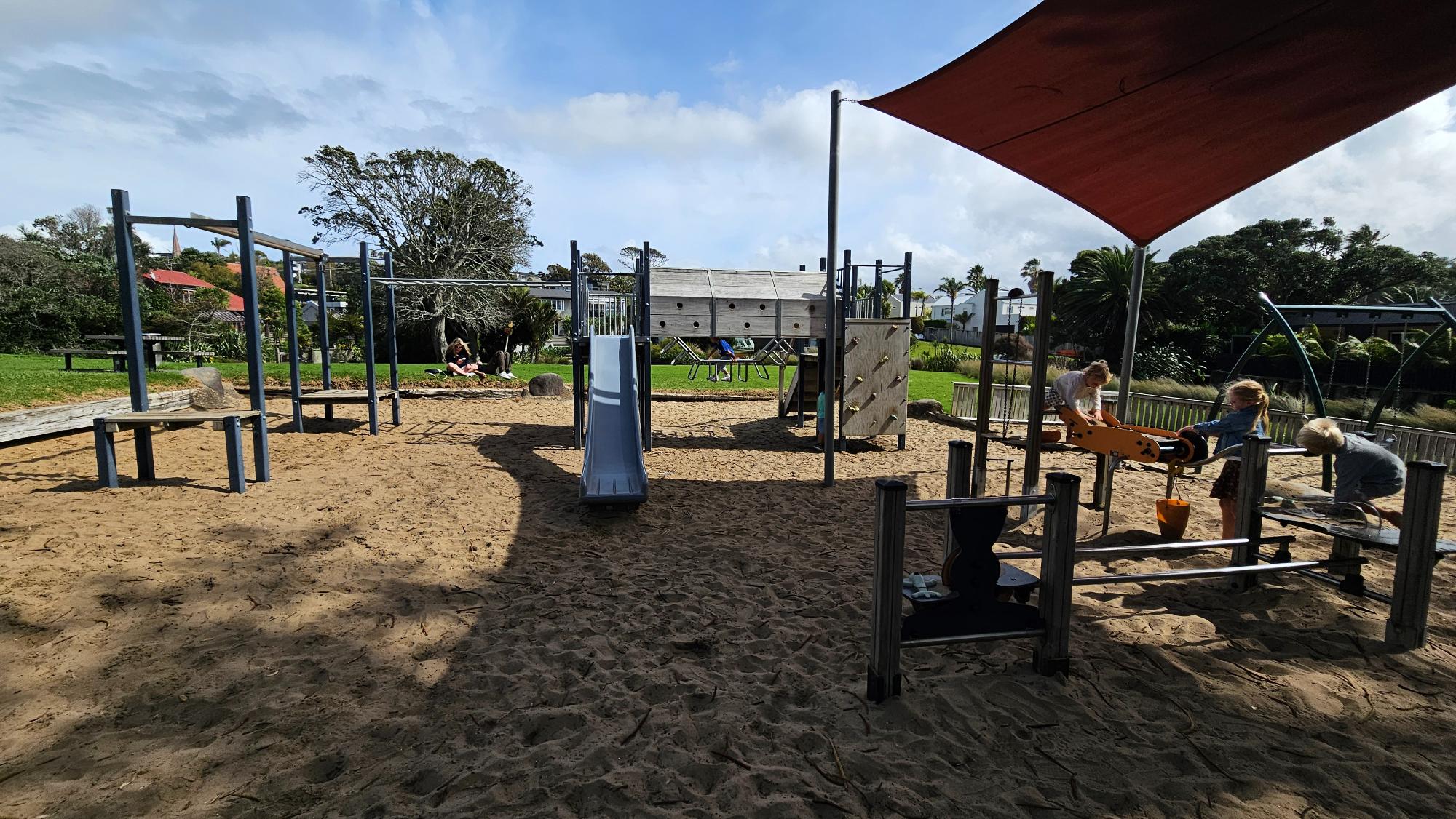 The whole playground is surfaced with deep sand — including a sand conveyor belt that younger kids love