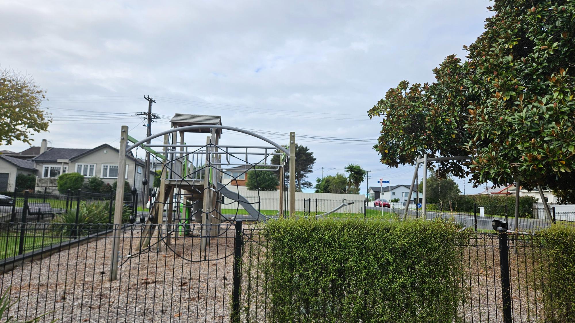 Fully fenced play area at Nile Reserve Playground with clear street visibility