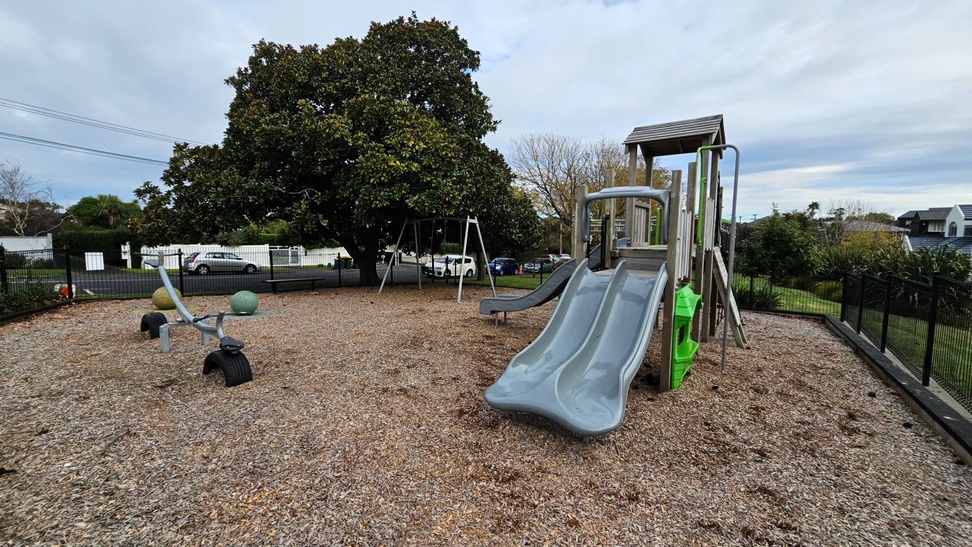 Wooden fort, dual slides, and rope climbing features at Nile Reserve Playground
