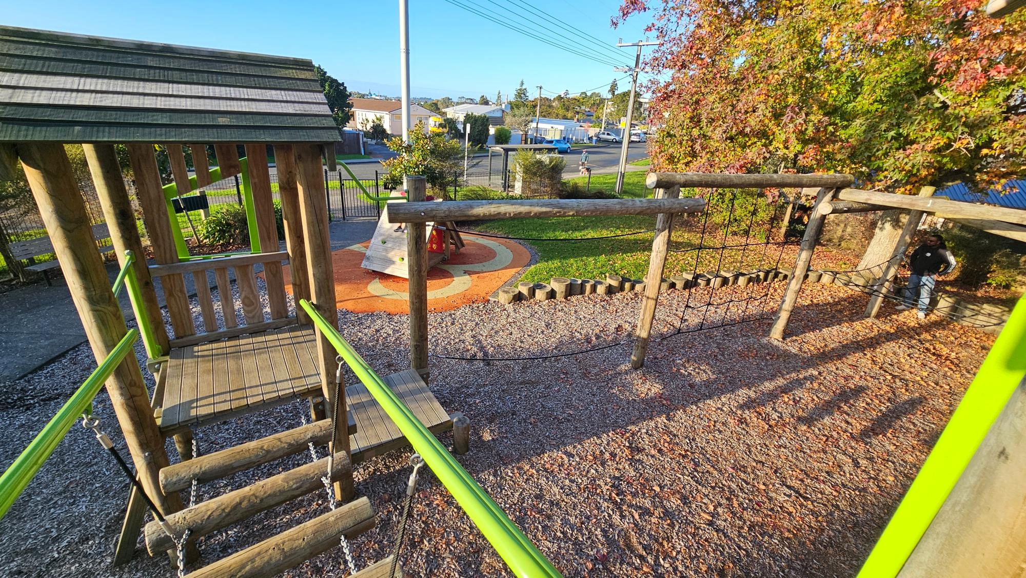 Multi-level wooden play fort with lime accents at Windy Ridge Reserve Playground
