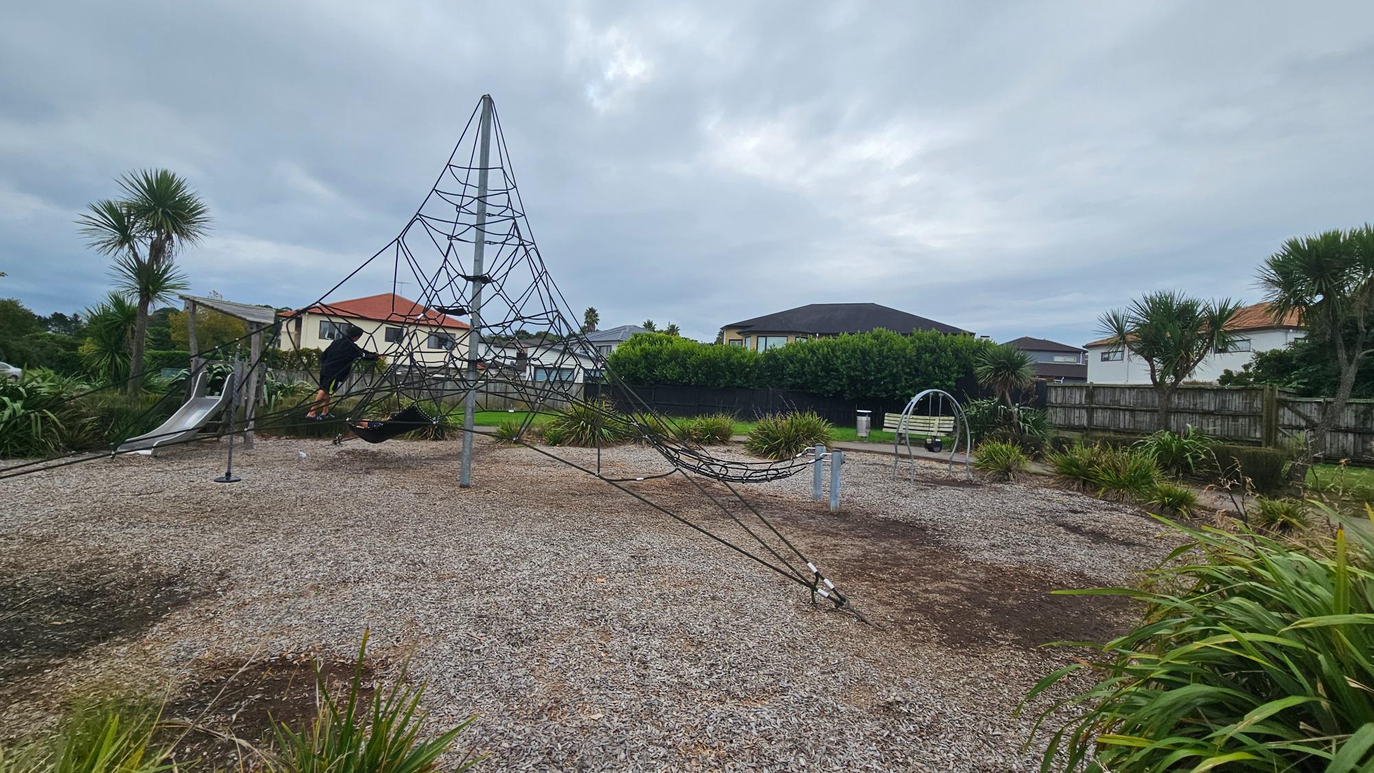 Swings, pyramid spider net, and toddler play at Glen Bay Close Reserve, Pinehill