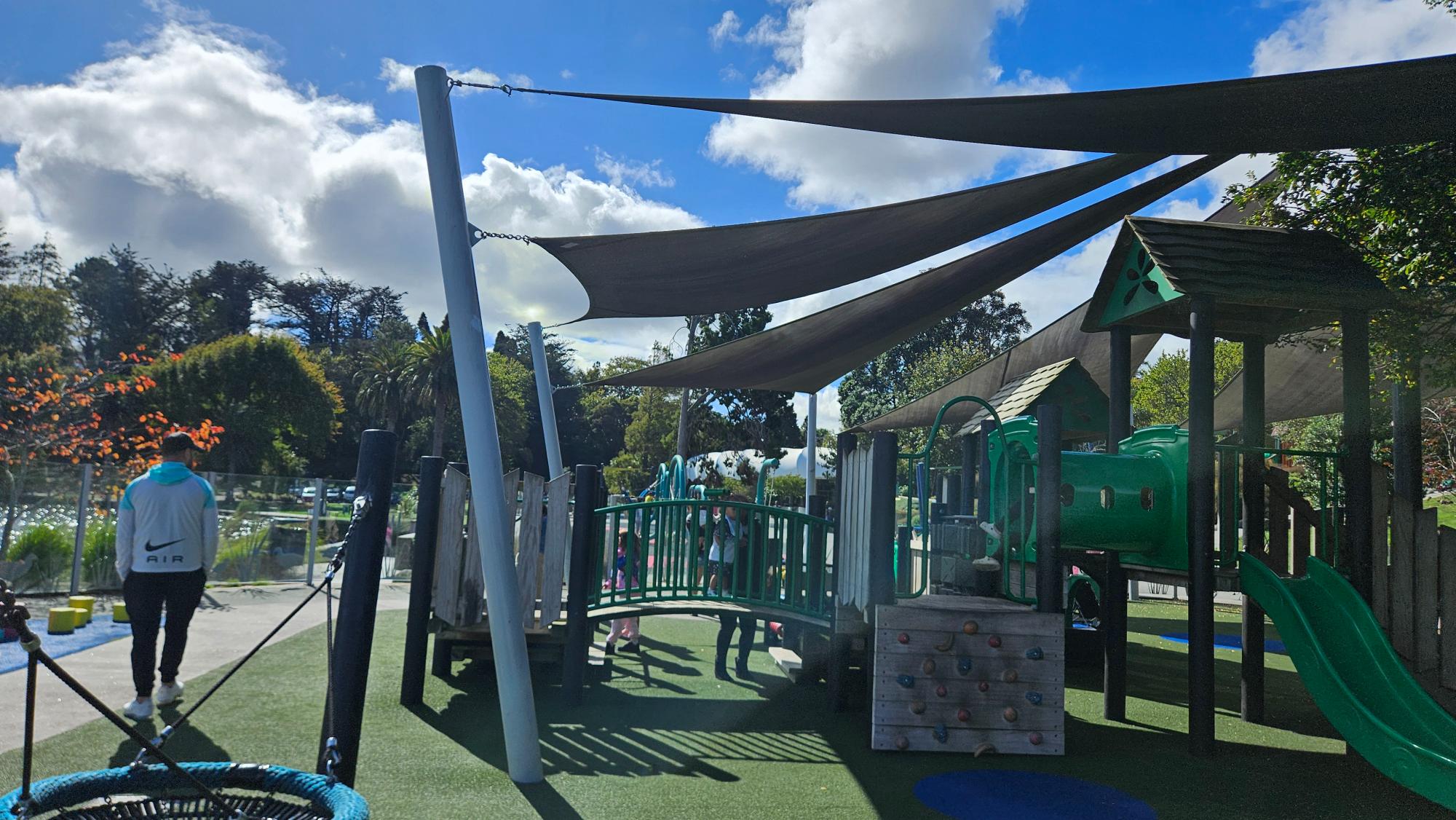Fully fenced toddler area with artificial turf, triple shade sails, and a gated entrance — Hamilton Lake Playground
