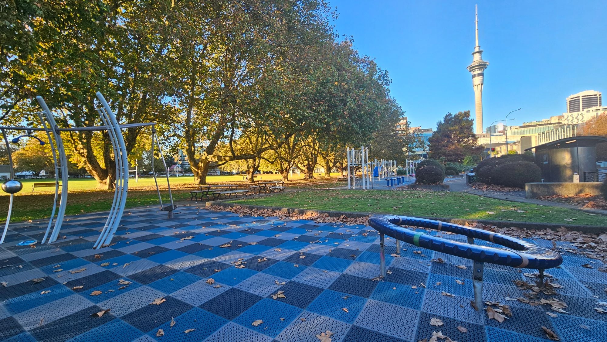Picnic tables and green space along the playground strip
