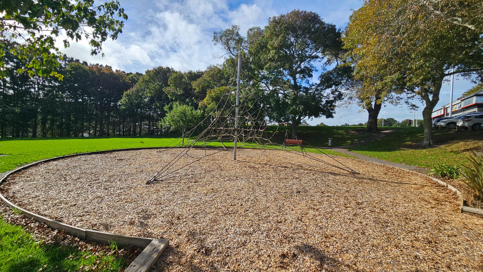 Large rope climbing pyramid at Kaipātiki Park Playground — a standout for climbers