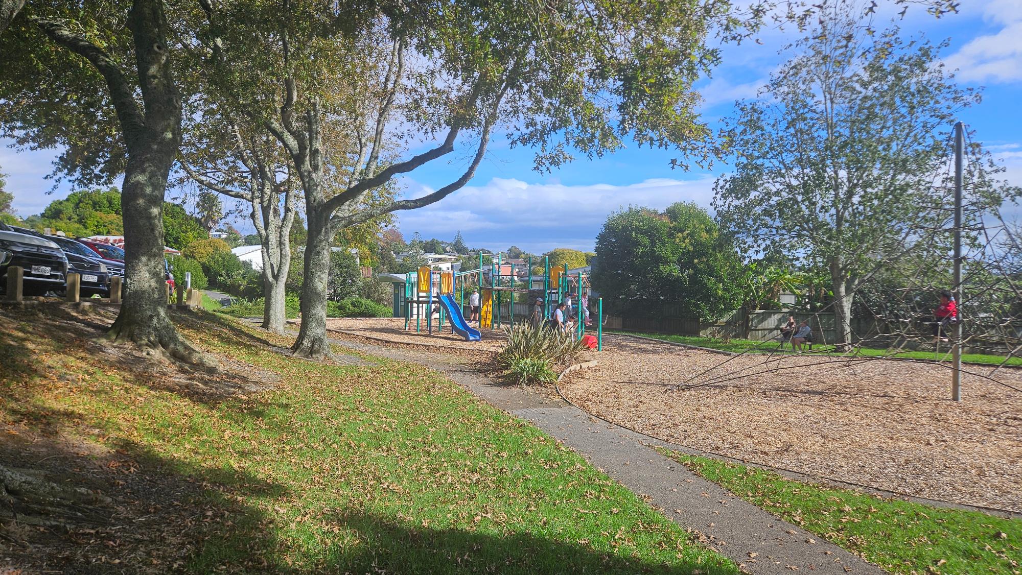 Kaipātiki Park — playground corner beside wide open fields and parkland