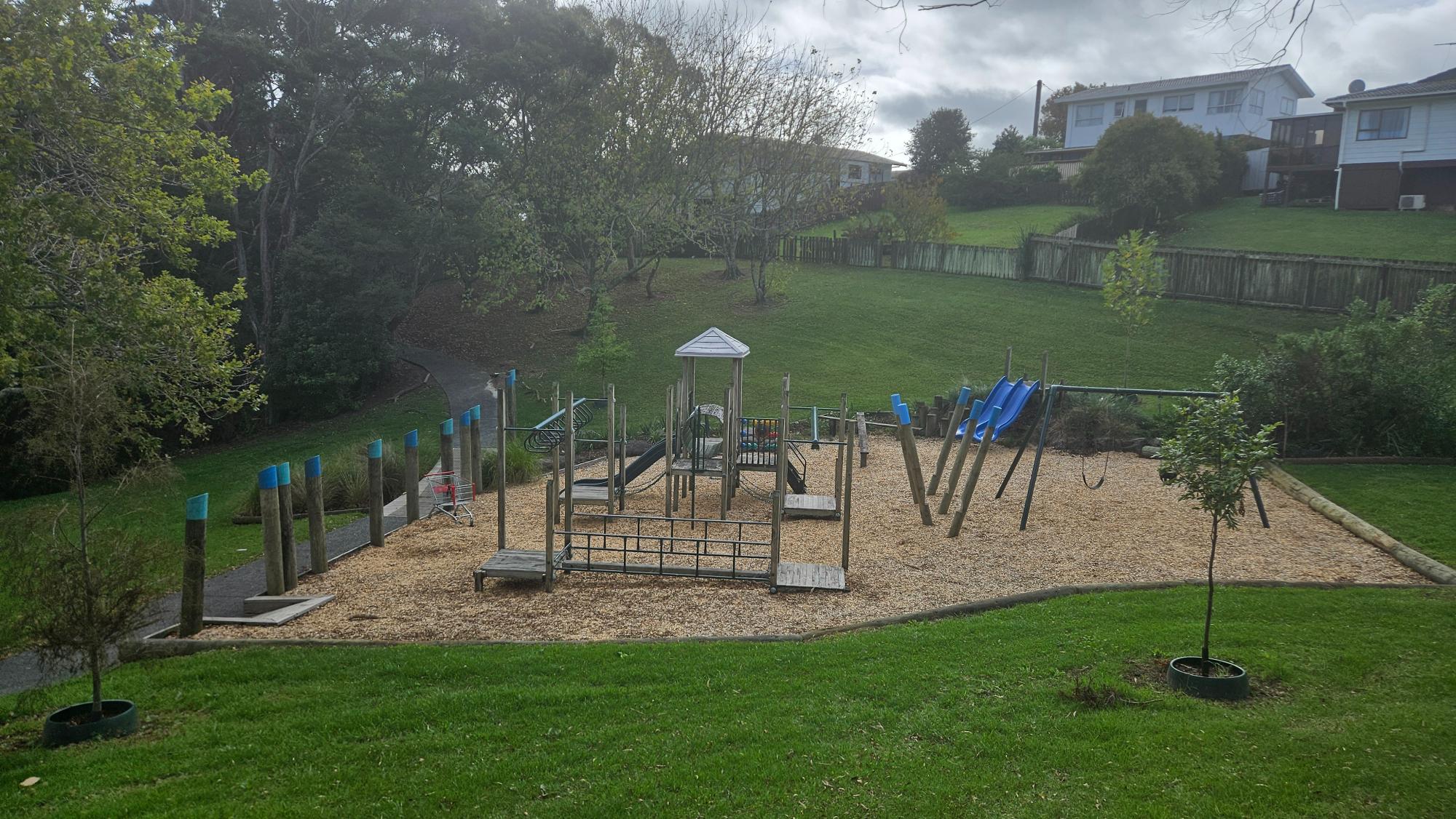 Tree-lined reserve and pathway beside Lancelot Reserve Playground