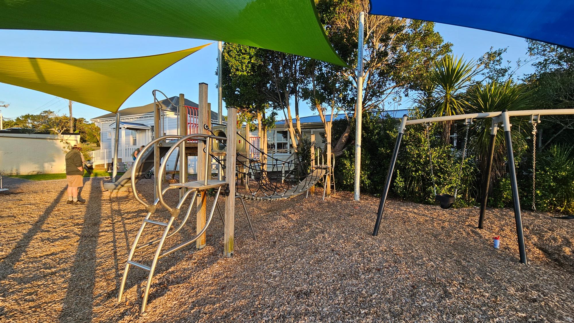Wooden stepping path and shade sails at Birkenhead War Memorial Park Playground