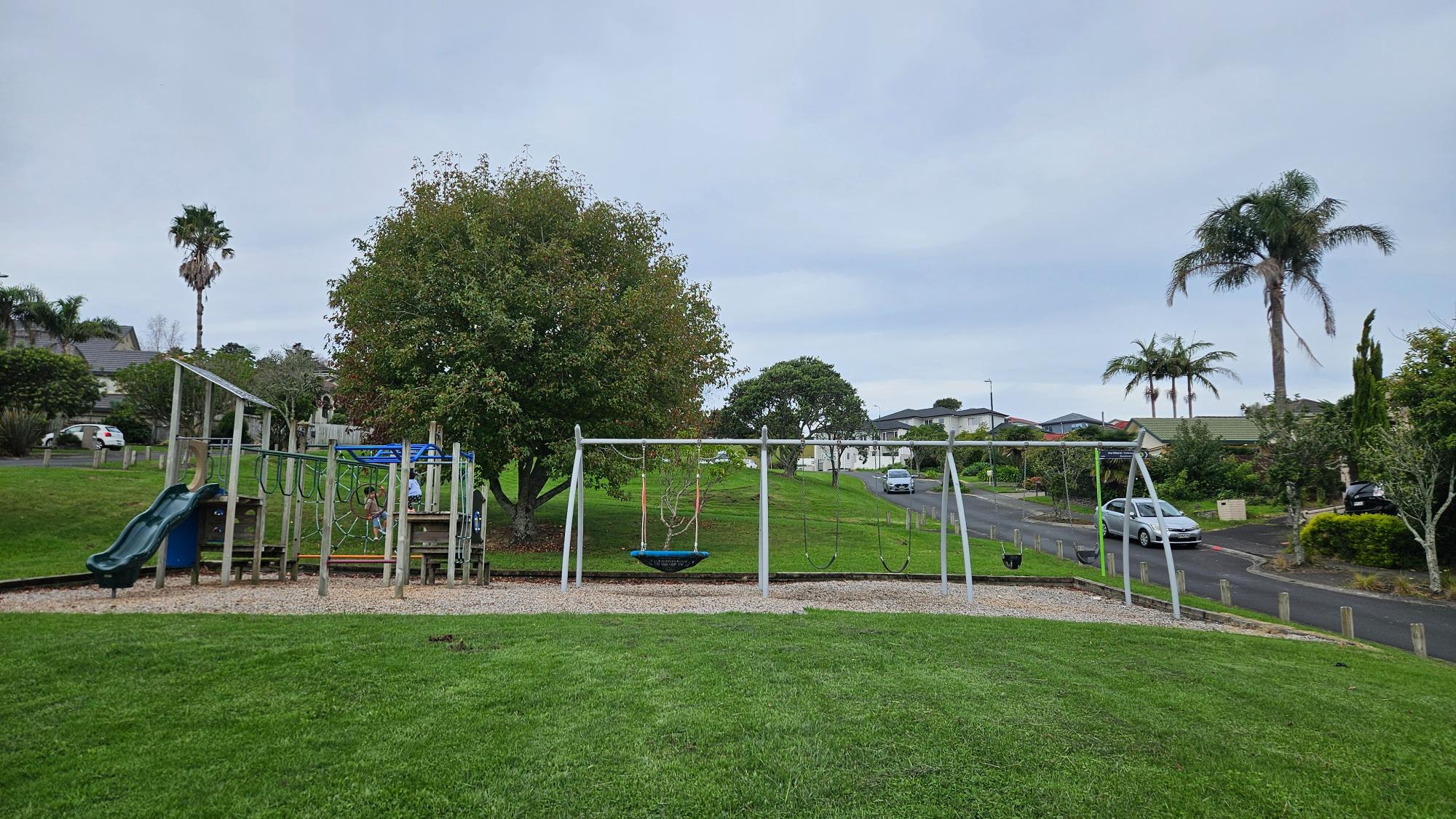 Taroka Reserve Playground and surrounding grass on the hillside, Pinehill — quiet residential setting