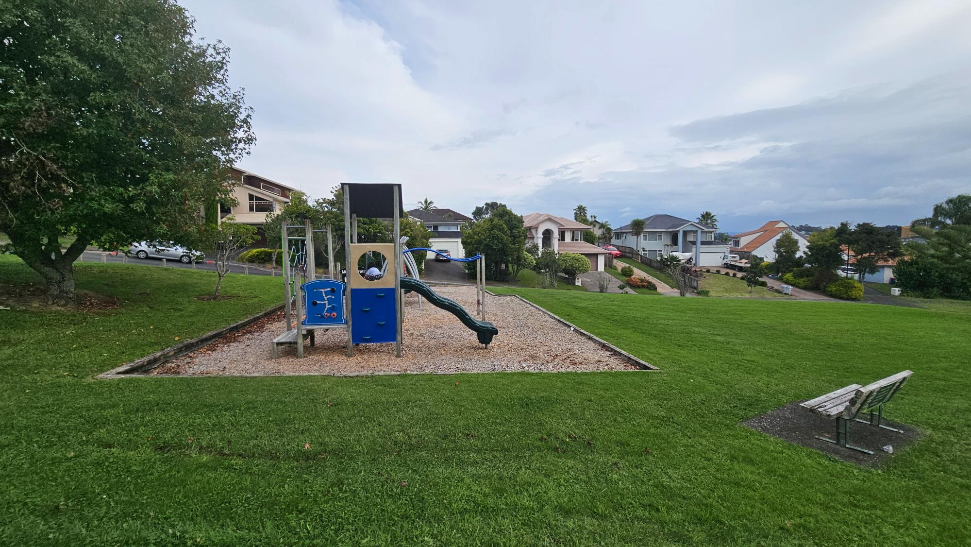 Grassy slope and reserve outlook from Taroka Close, Pinehill