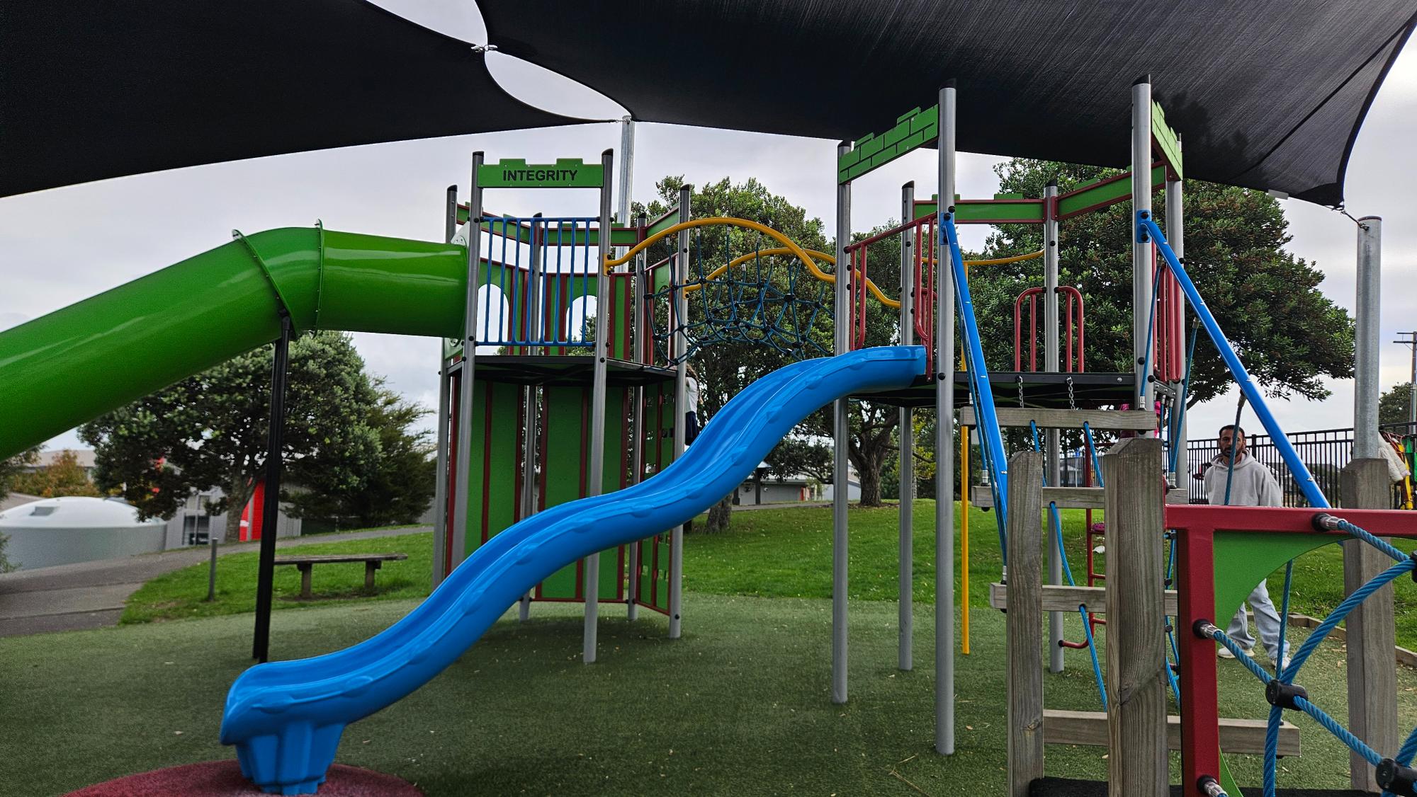 Artificial turf, play structures, and shaded area at Pinehill School Playground, Pinehill